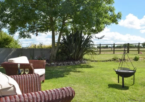 The outdoor sitting area, firepit & garden at Hafan Fach Cottage, Maidenwells