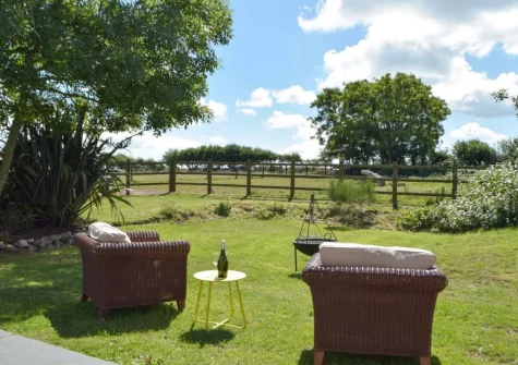 The outdoor sitting area, firepit & garden at Hafan Fach Cottage, Maidenwells