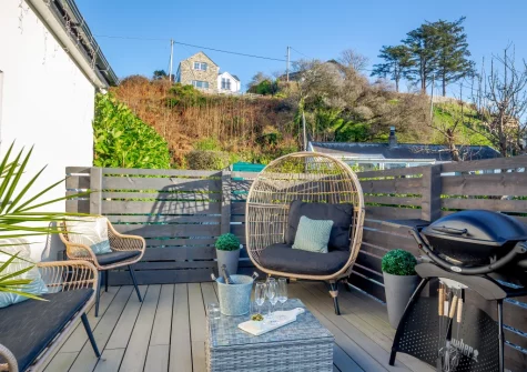 The decked terrace, barbecue & outdoor sitting area at Hafan Glas, Abersoch