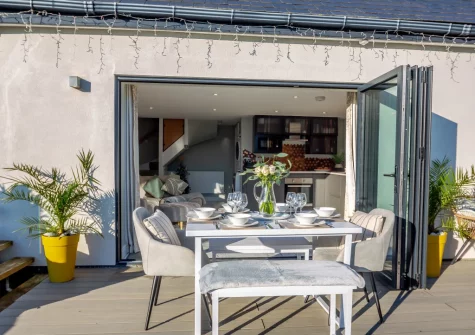 The decked terrace, barbecue & alfresco dining area at Hafan Glas, Abersoch