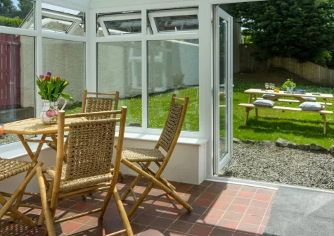 The sunny conservatory at Hawthorn Cottage at Woodlands Farm, Little Haven