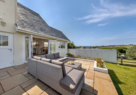 The patio, outdoor sitting area & enclosed lawned garden at Hillside, Abersoch
