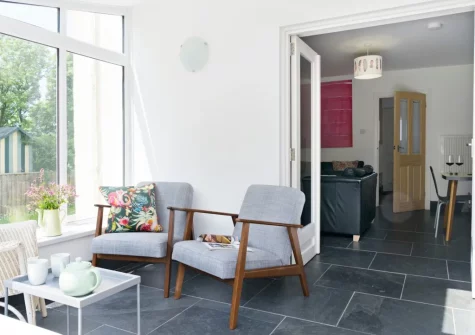 The conservatory sitting area at Holly Cottage at Woodlands Farm, Little Haven