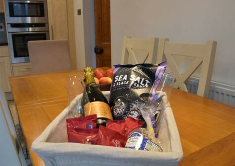 The dining area & welcome basket at Holly Cottage, Haverfordwest