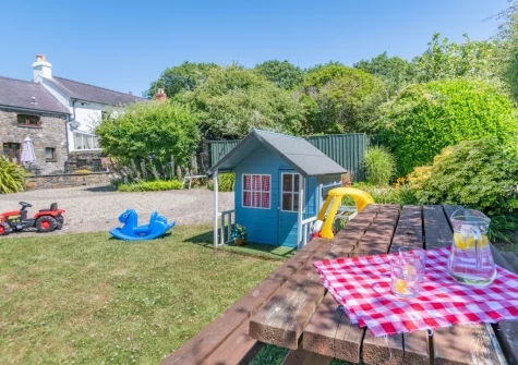 The large shared lawn with children's play area at Holly Cottage, Haverfordwest