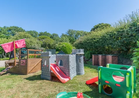The large shared lawn with children's play area at Holly Cottage, Haverfordwest