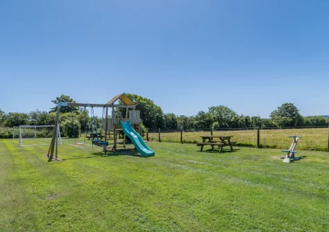 The large shared lawn with children's play area at Holly Cottage, Haverfordwest