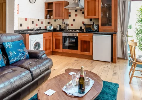 Holly Cottage, Haverfordwest, is a charming two-bedroom retreat in converted stone outbuildings with period features and lovely countryside views. Enjoy a children's play area, shared gardens, and easy access to Pembrokeshire's stunning beaches.