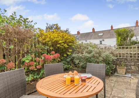 The patio & alfresco dining area at Honeysuckle Cottage, Broad Haven