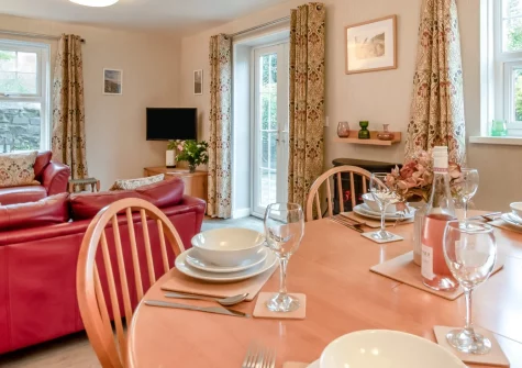 Honeysuckle Cottage, Broad Haven is a charming two-bedroom retreat just 260 metres from golden sands, featuring a fully enclosed garden perfect for families and dogs, cosy interiors with a warming fire, and designated parking for coastal adventures.