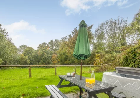 The patio, alfresco dining area, hot tub & gaden at Hunter's Hollow, St Florence