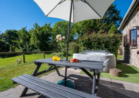 The patio, alfresco dining area, hot tub & gaden at Hunter's Hollow, St Florence