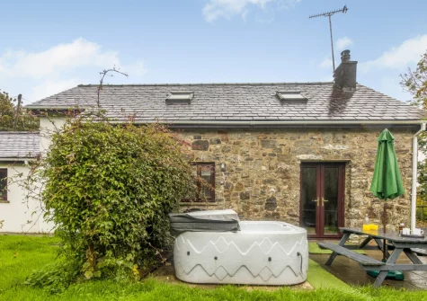 The patio, alfresco dining area, hot tub & gaden at Hunter's Hollow, St Florence