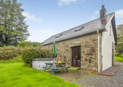 The patio, alfresco dining area, hot tub & gaden at Hunter's Hollow, St Florence