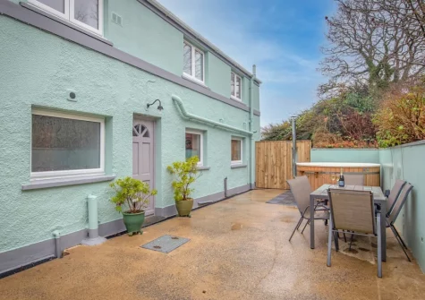The patio, alfresco dining area & large wood-fired hot tub at Incline Villa, Saundersfoot