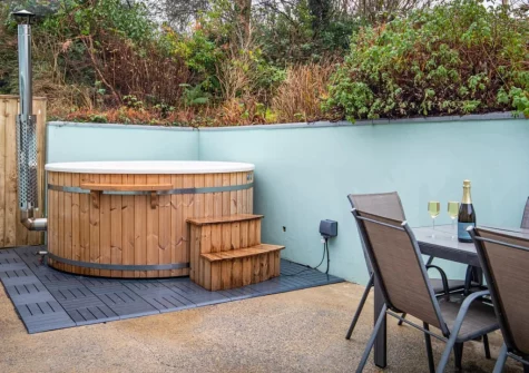 The patio, alfresco dining area & large wood-fired hot tub at Incline Villa, Saundersfoot