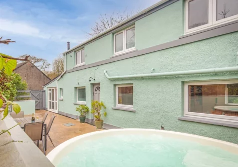 The patio, alfresco dining area & large wood-fired hot tub at Incline Villa, Saundersfoot