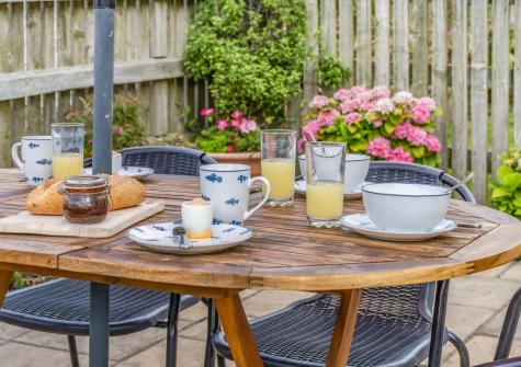 The pretty patio garden & alfresco dining area at Just Beachy, Broad Haven