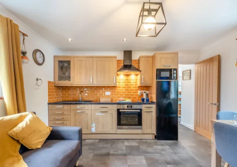 The living area & kitchen at Keepers Cottage at East Tarr Farm, St Florence