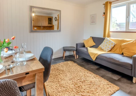 Keepers Cottage, St Florence is a charming two-bedroom cottage on a working Pembrokeshire farm, with a private hot tub, enclosed patio, dog-friendly interiors, use of a heated pool, and easy access to Tenby's golden beaches and family attractions.