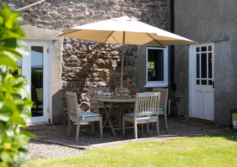 The patio, alfresco dining area & enclosed garden at Kelwon Cottage, St Brides