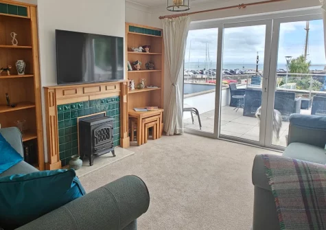 Landfall, Saundersfoot is a charming three-bedroom house boasting spectacular harbour and beach views from the heart of this popular seaside village, featuring a private balcony, coastal interiors, and Pembrokeshire's golden beaches mere steps away.