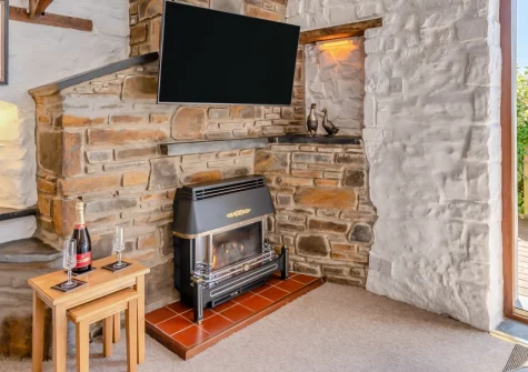 Lavender Cottage, Haverfordwest is a characterful stone retreat for couples or young families, featuring vaulted beamed ceilings, a sunny south-facing deck with countryside views, and a shared play area, just five miles from Broad Haven Beach.