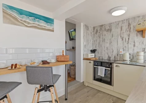 The kitchen with breakfast bar dining area at Lighthouse Row, St Annes Head