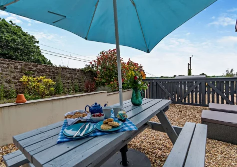 The gravel patio, barbecue & alfresco dining area at Loveston Lodge, Loveston