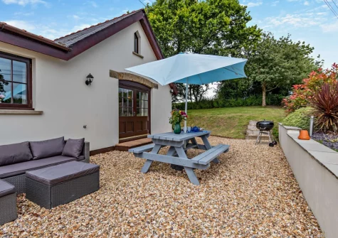 The gravel patio, barbecue, alfresco dining & outdoor sitting area at Loveston Lodge, Loveston
