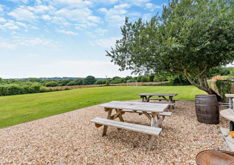 You have access to a shared playing field, barbecue & firepit