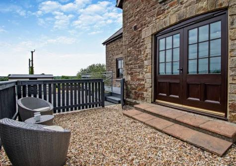 The balcony terrace & outdoor sitting area at Loveston School House, Loveston