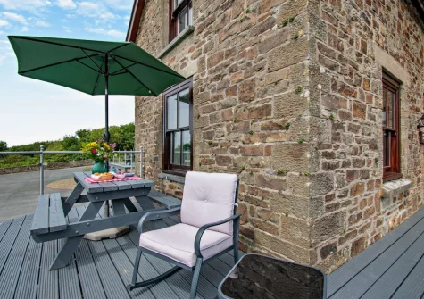 The decked balcony terrace & alfresco dining area at Loveston School House, Loveston