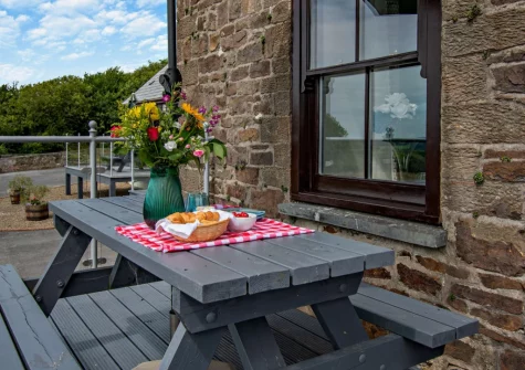The decked balcony terrace & alfresco dining area at Loveston School House, Loveston