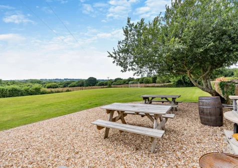 You have access to a shared playing field, barbecue & firepit