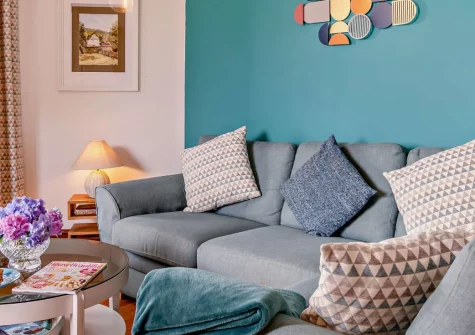 Loveston School House, Loveston is a charming two-bedroom cottage in a converted school building, featuring a balcony overlooking Pembrokeshire countryside, shared play areas with firepit, and easy access to coastal beaches and attractions.