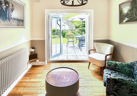 The sitting area, with french doors leading out to the patio & garden, at Miners Arms Cottage, Stepaside