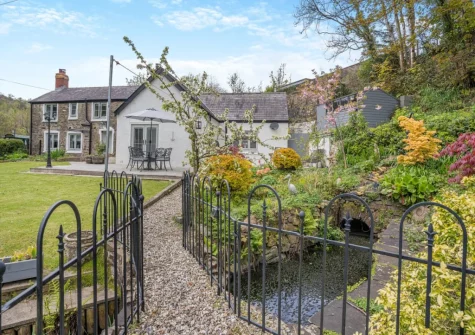 The lawned rear garden & stream at Miners Arms Cottage, Stepaside