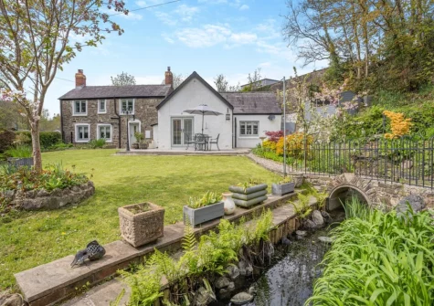 The lawned rear garden & stream at Miners Arms Cottage, Stepaside
