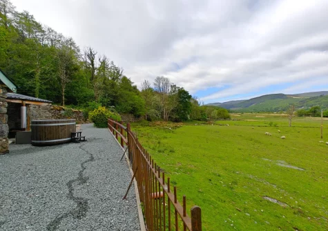 The private wood-fired hot tub & enclosed garden at Minffordd, Penmaenpool