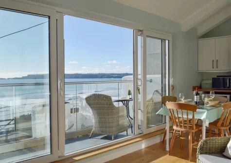 The living, dining area & balcony at Mole End, Amroth