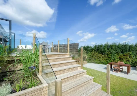 The large decked terrace, alfresco dining area & lawned garden at Morannedd, Bwlchtocyn