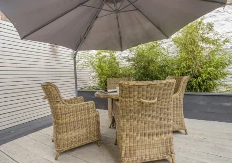 The decked suntrap garden & alfresco dining area at Mulberry Cottage, Conwy