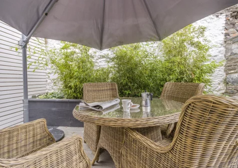The decked suntrap garden & alfresco dining area at Mulberry Cottage, Conwy