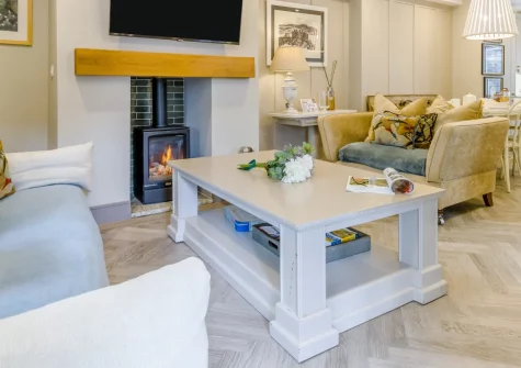 Mulberry Cottage, Conwy is a charming two-bedroom house in the heart of the historic walled town, featuring a sun-trap garden, cosy wood burner, his and hers bathroom sinks, and easy access to the castle, beaches, and north Wales coast.