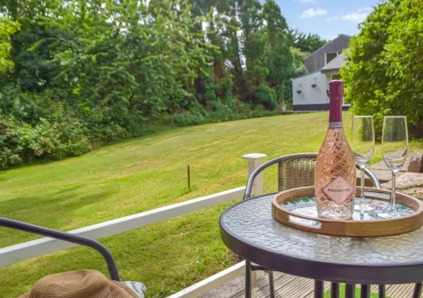 The small private patio, outdoor sitting area & shared garden at Mutton Hill Cottage, Pembroke