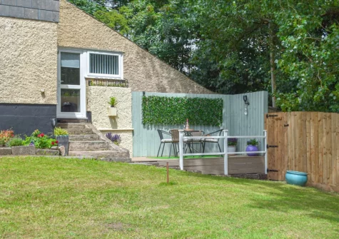 The small private patio, outdoor sitting area & shared garden at Mutton Hill Cottage, Pembroke