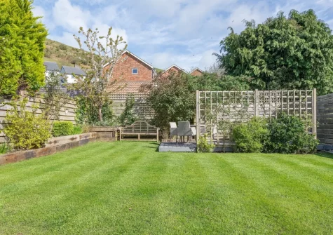 The patio, hot tub, alfresco dining area & enclosed lawned garden at Nyth yr Wylan, Aberdovey