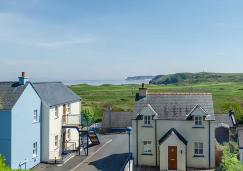 The panoramic views of Tenby Golf Club & coastline from the living room at Ocean Breeze, Penally