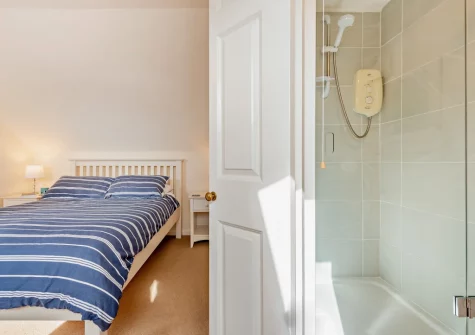 bedroom #1 & en-suite shower room at Ol Tywydd, Broad Haven